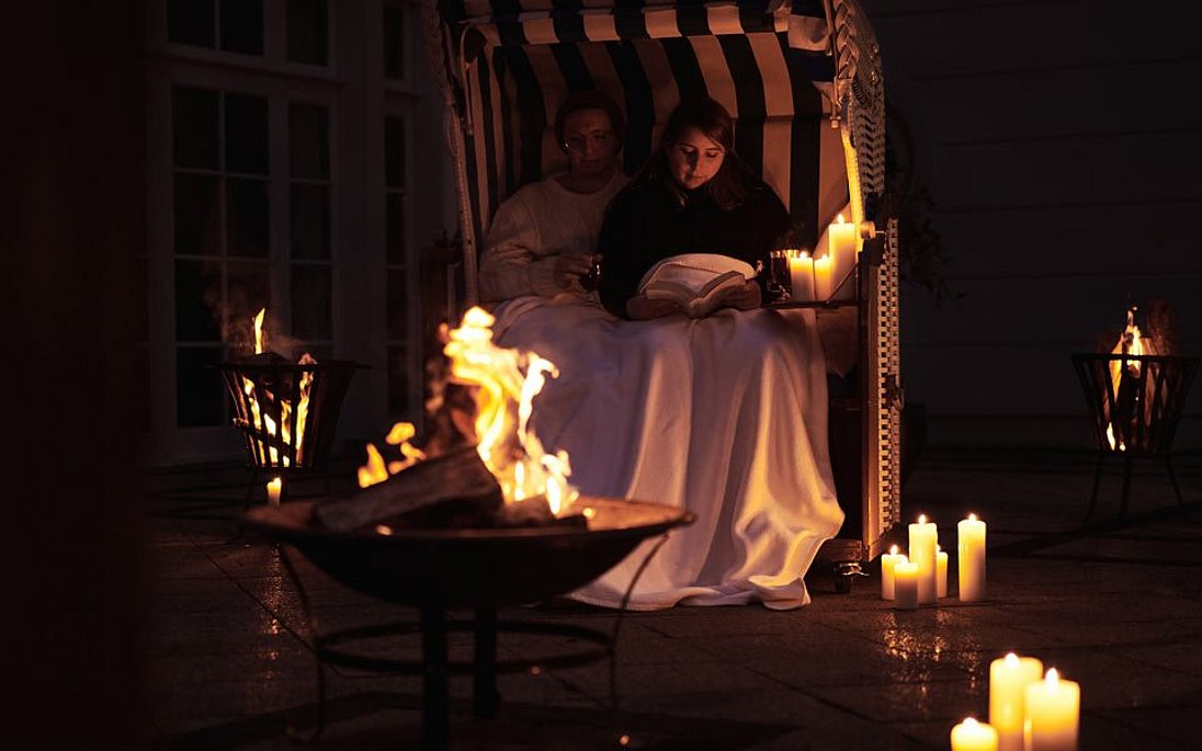 Couple enjoys candlelight atmosphere in beach chair